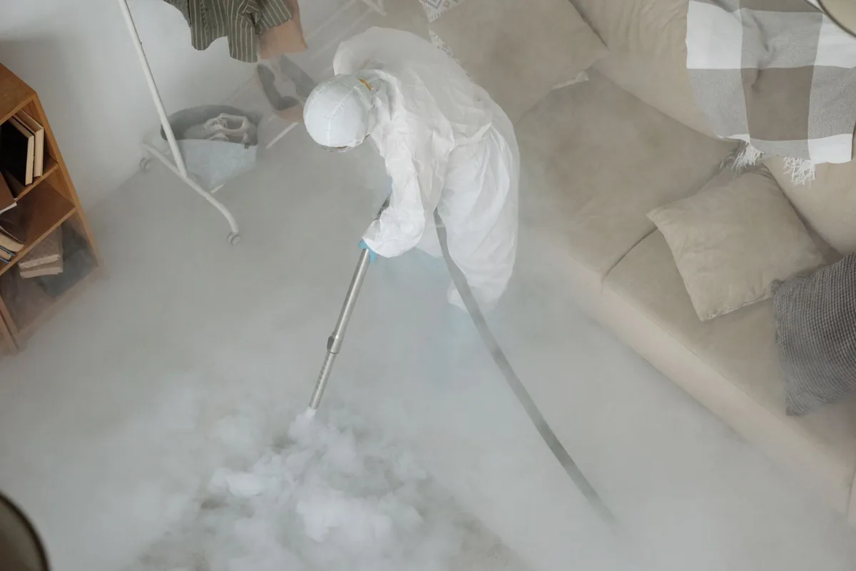 Biohazard cleanup technician in protective equipment, Siloam Springs, AR